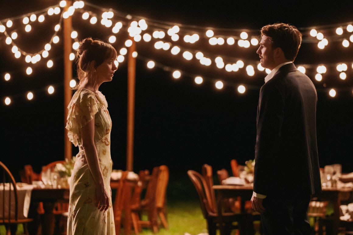 Romantic couple at outdoor wedding reception under string lights, celebrating love and commitment.
(L–R) Dakota Johnson and Chris Evans in Materialists (2024). Photo by Atsushi Nishijima. © A24. Image courtesy of A24 Press.