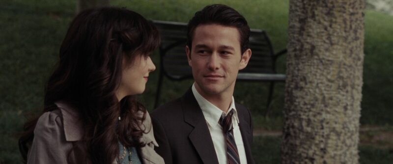 Jason Journal film scene of a man and woman sitting outdoors in park setting.
