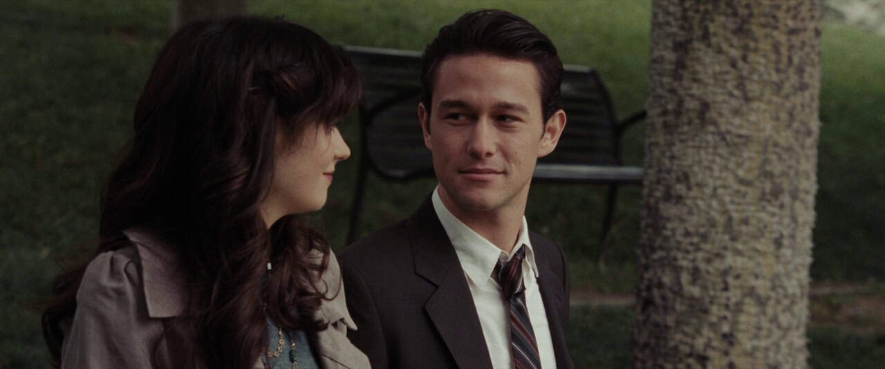 Jason Journal film scene of a man and woman sitting outdoors in park setting.
