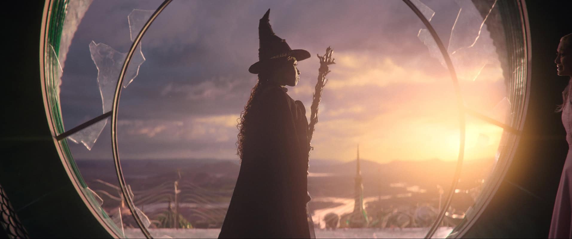 Silhouette of a witch at sunset.
Still from Wicked (2024), featuring Cynthia Erivo. © Universal Pictures. Image sourced via UniversalPictures.co.uk.